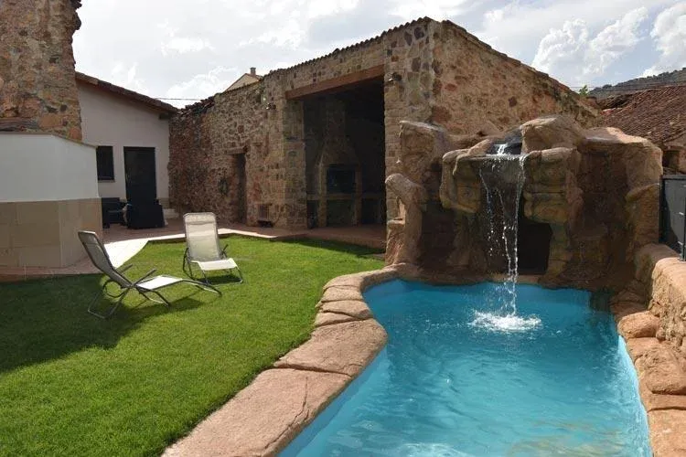 Imagen de Vistas del jardín, piscina y barbacoa de la casa rural La Cueva del Agua.